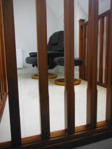 a reflection of a chair in a mirror at Inspiration Lodge in Anascaul