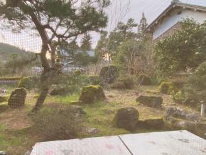 a view of a cemetery through a window at 田舎生活体験福井県観光者向け古民家 in Sabae