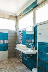 a bathroom with a sink and a mirror at Villa Flora in Sozopol +77 photos