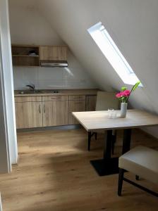 a kitchen with a table and a kitchen with a window at A Lotus Hotel in Böblingen