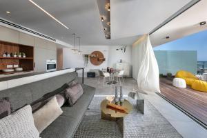 a living room with a couch and a table at Alonas Apartments Beachfront Apartment in Haifa