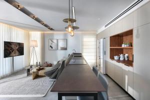a dining room with a long table and chairs at Alonas Apartments Beachfront Apartment in Haifa