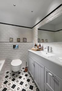a bathroom with a toilet and a sink and a tub at Beach Lux Apartment in Haifa