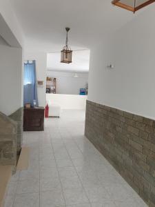 a room with a brick wall and a tile floor at SUNRISE VIEW in Livadi