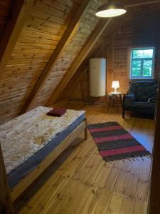 a bedroom with a bed and a couch in a attic at DOMY na GÓRCE in Narty