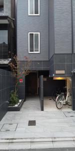 a building with a bike parked in front of it at Miyabiro 105 in Kyoto