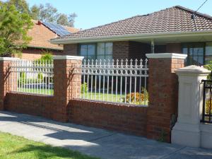 a brick fence in front of a house at Effie Court in Springvale South