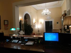 a desk with a laptop computer on top of it at Hotel del Centro in Palermo