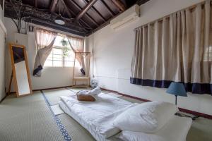 a bedroom with a large bed and a window at ZYIN Homestay in Kaohsiung