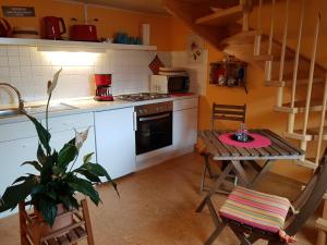 a small kitchen with a table and a table and chairs at Ferienwohnung Zum-alten-Kirschbaum in Limburg an der Lahn