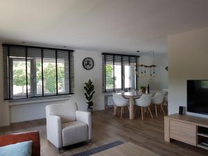 a living room and dining room with a table and chairs at Dolce Vita Gerolstein -Dani in Gerolstein