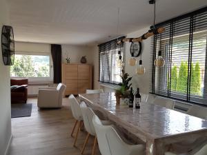 a dining room with a large table and white chairs at Dolce Vita Gerolstein -Dani in Gerolstein