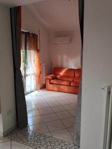 a living room with a couch and a tile floor at Sul Confine in Cervia