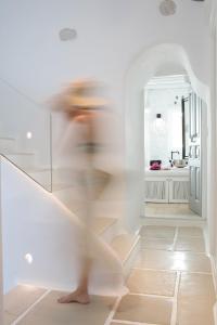 a person walking down the stairs in a room at Euphoria Downtown in Naxos Chora