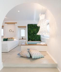 a room with two beds and a bathroom with a mirror at Euphoria Downtown in Naxos Chora
