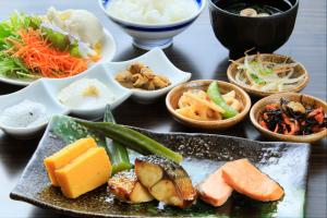 a table with a bunch of different types of food at Daiwa Roynet Hotel Tokyo Akabane in Tokyo +88 photos
