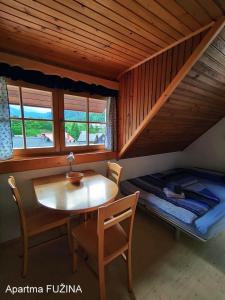 a room with a table and a bed in a cabin at Apartment Cesar in Bohinj