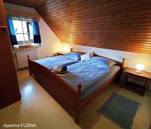 a bedroom with a large bed with a wooden ceiling at Apartments Cesar in Bohinj