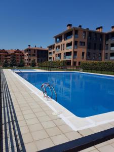 a large swimming pool in front of some buildings at Apartamento Vive Jaca in Jaca