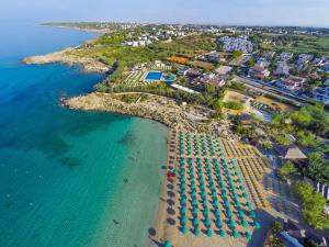 an aerial view of a beach with umbrellas and the ocean at HB Le suites del Giardino in Taranto
