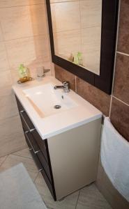 a bathroom with a white sink and a mirror at Casa Hortensia in Mangalia +20 photos