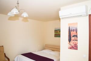 a bedroom with a bed and a air conditioner at Casa Hortensia in Mangalia