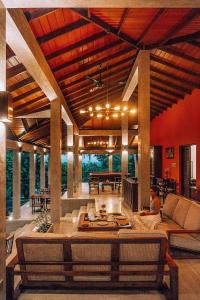 a large living room with couches and a table at Aarunya Nature Resort and Spa in Kandy