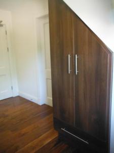 a large wooden cabinet in a room with wooden floors at Inspiration Lodge in Anascaul