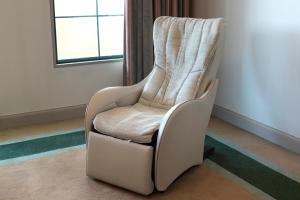 a white chair in a room with a window at Hotel Marital Sousei Kurume in Kurume