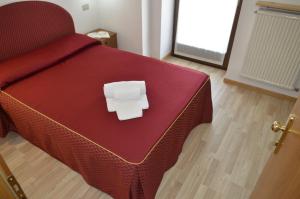 Postel nebo postele na pokoji v ubytování Hotel Corona