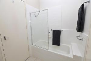 a bathroom with a shower with a glass door at Downstairs in Hawthorn in Melbourne