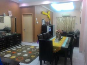 a living room with a dining room table and a dining room at Numero X homestay in Kajang