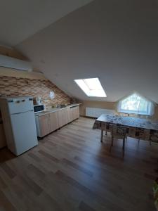 a kitchen with a table and a refrigerator in a room at Гостевой дом in Chornomorsk