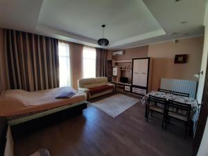 a bedroom with a bed and a desk in a room at Гостевой дом in Chornomorsk