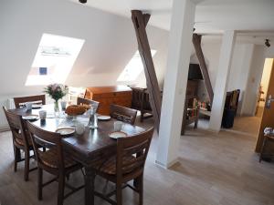 a dining room with a wooden table and chairs at Ferienhof Meyer in Nahrendorf