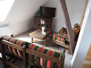 a living room with a couch and a tv at Ferienhof Meyer in Nahrendorf