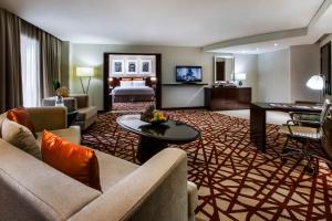 a living room filled with furniture and a tv at Crowne Plaza Dubai Deira, an IHG Hotel in Dubai