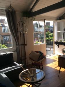 a living room with a couch and a glass table at Beautiful City Centre Apartment with Cathedral View in St. Albans