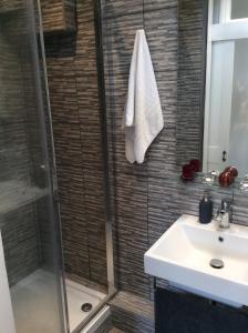 a bathroom with a shower and a sink at Beautiful City Centre Apartment with Cathedral View in St. Albans +16 photos