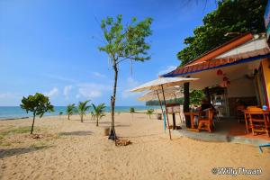 a restaurant on the beach next to the ocean at Title Residence Naiyang Beach Phuket in Nai Yang Beach