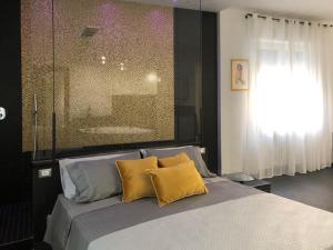 a bedroom with a bed with two yellow pillows at Romantic Apartment Verona in Verona