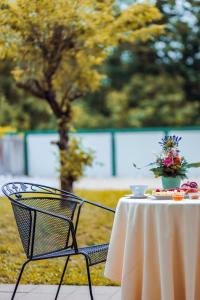 a white table with a vase of flowers on it at Hotel Fontana in Bad Kissingen
