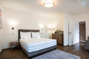 a bedroom with a large white bed and a couch at Hotel MAGISTR Vsetín in Vsetín