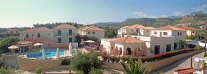 a group of houses and a pool in a resort at Georges Estates Hotel in Stoupa