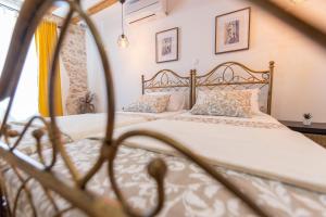 a bedroom with a bed with white sheets and pillows at Apartment Seka Oldtown in Senj +45 photos