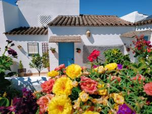 a garden of flowers in front of a house at Casa Campana in Arcos de la Frontera