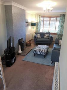 a living room with a couch and a tv at Highland Home From Home in Inverness