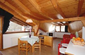 a kitchen and dining room with a table and chairs at Residence Trunka Lunka in Cavalese