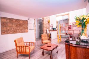 a living room with chairs and a table at B&B L'Orlando Furioso in Palermo