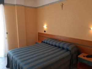 Postel nebo postele na pokoji v ubytování Hotel Pegaso